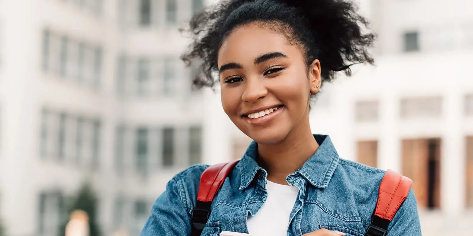 Smiling girl outside her school