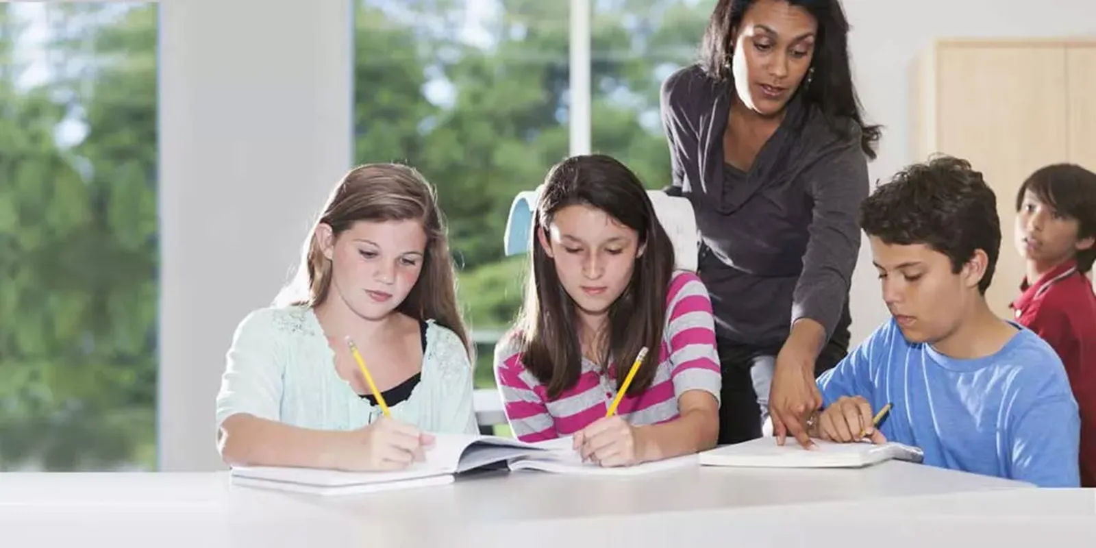 Teacher and students at a table